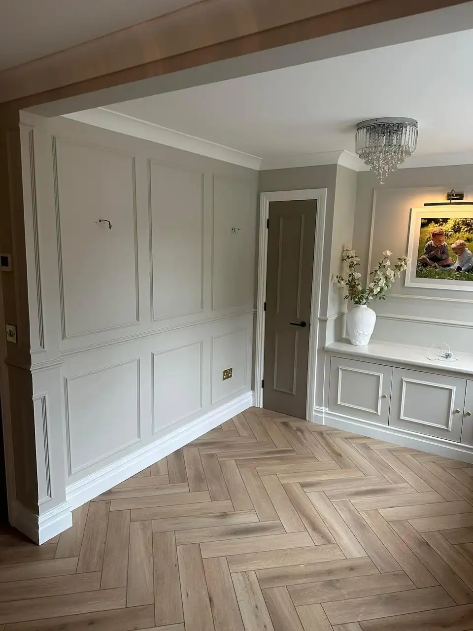 Hallway with white painted wall panelling and herringbone floor, decorated by JM Painters & Decorators in Solihull
